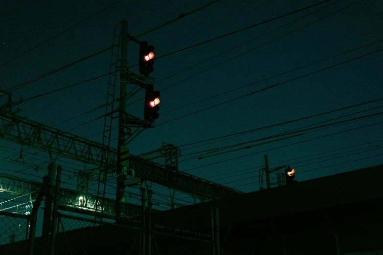 a traffic light on a wire at night time