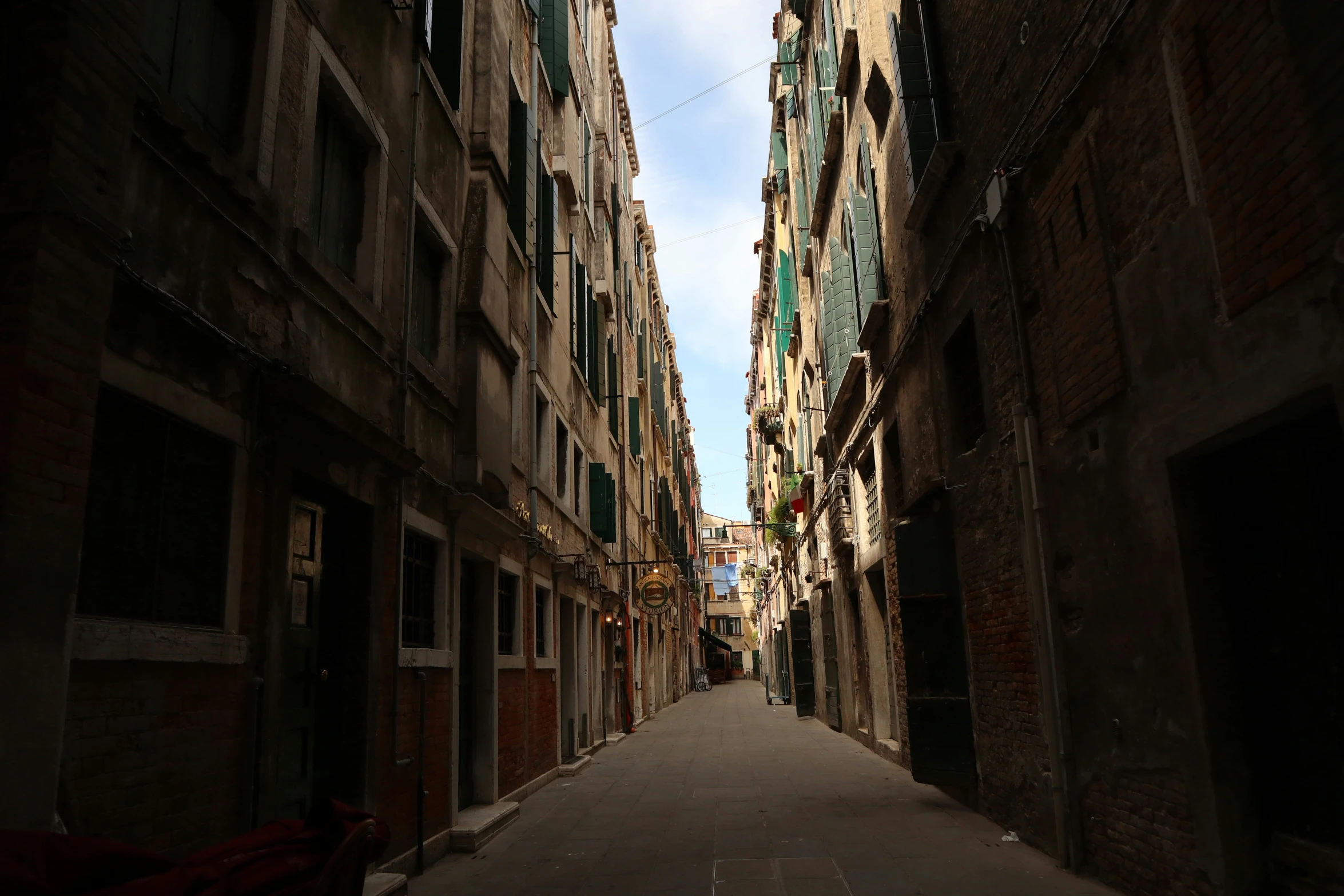 narrow street between buildings with doors on both sides