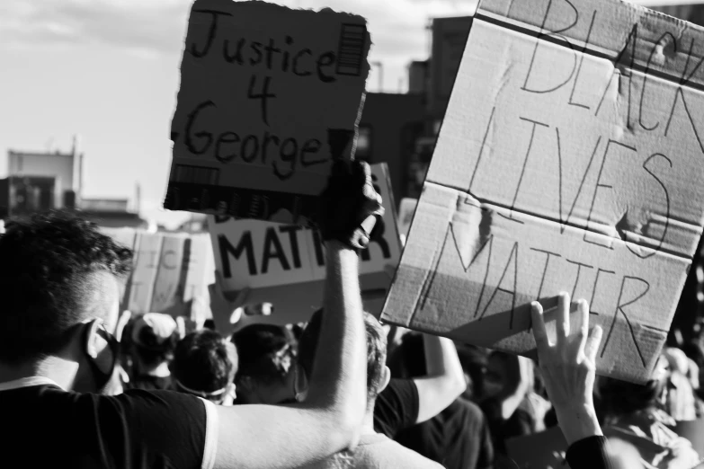 black and white po of a crowd of people holding signs
