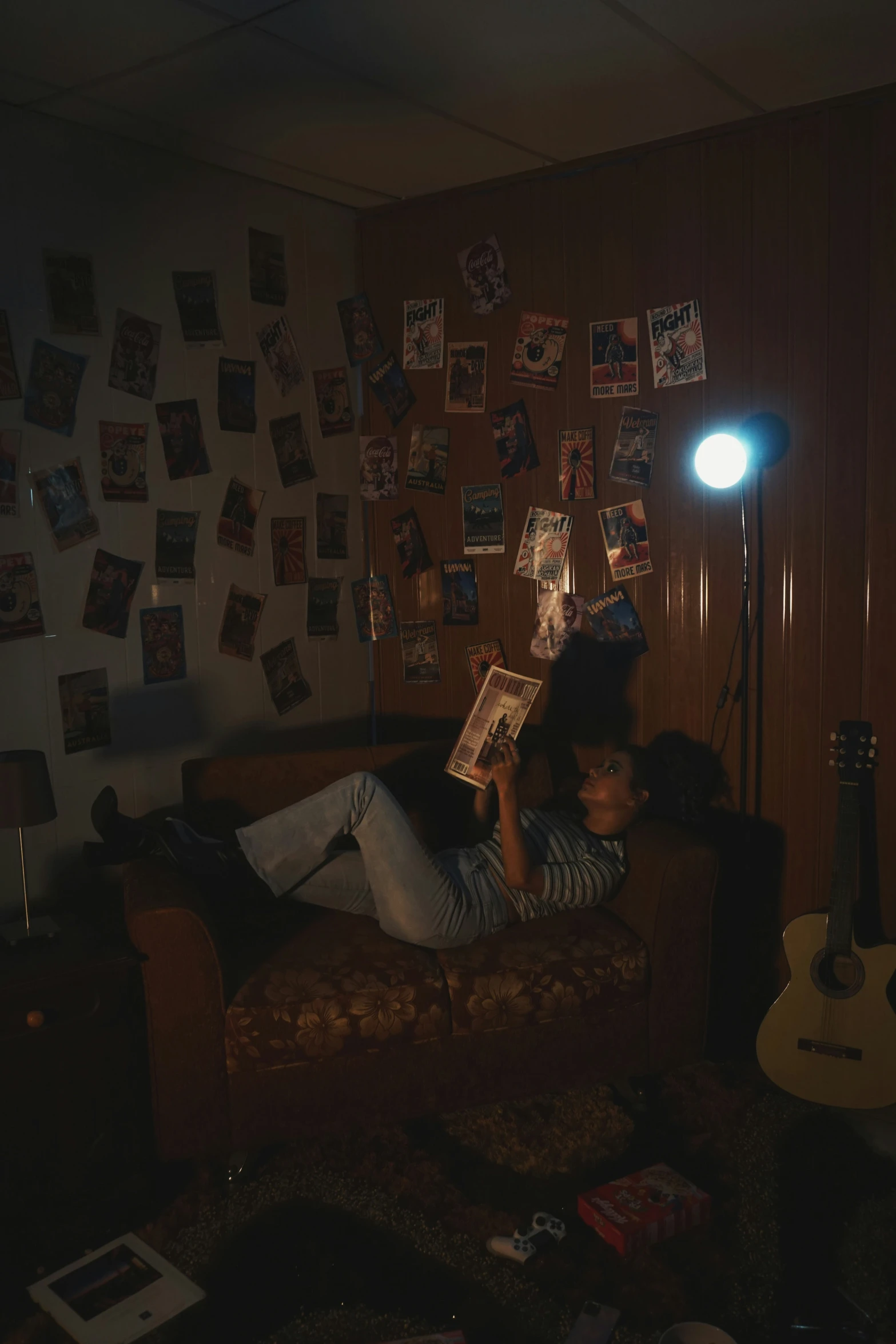 a person is laying on a couch reading a book