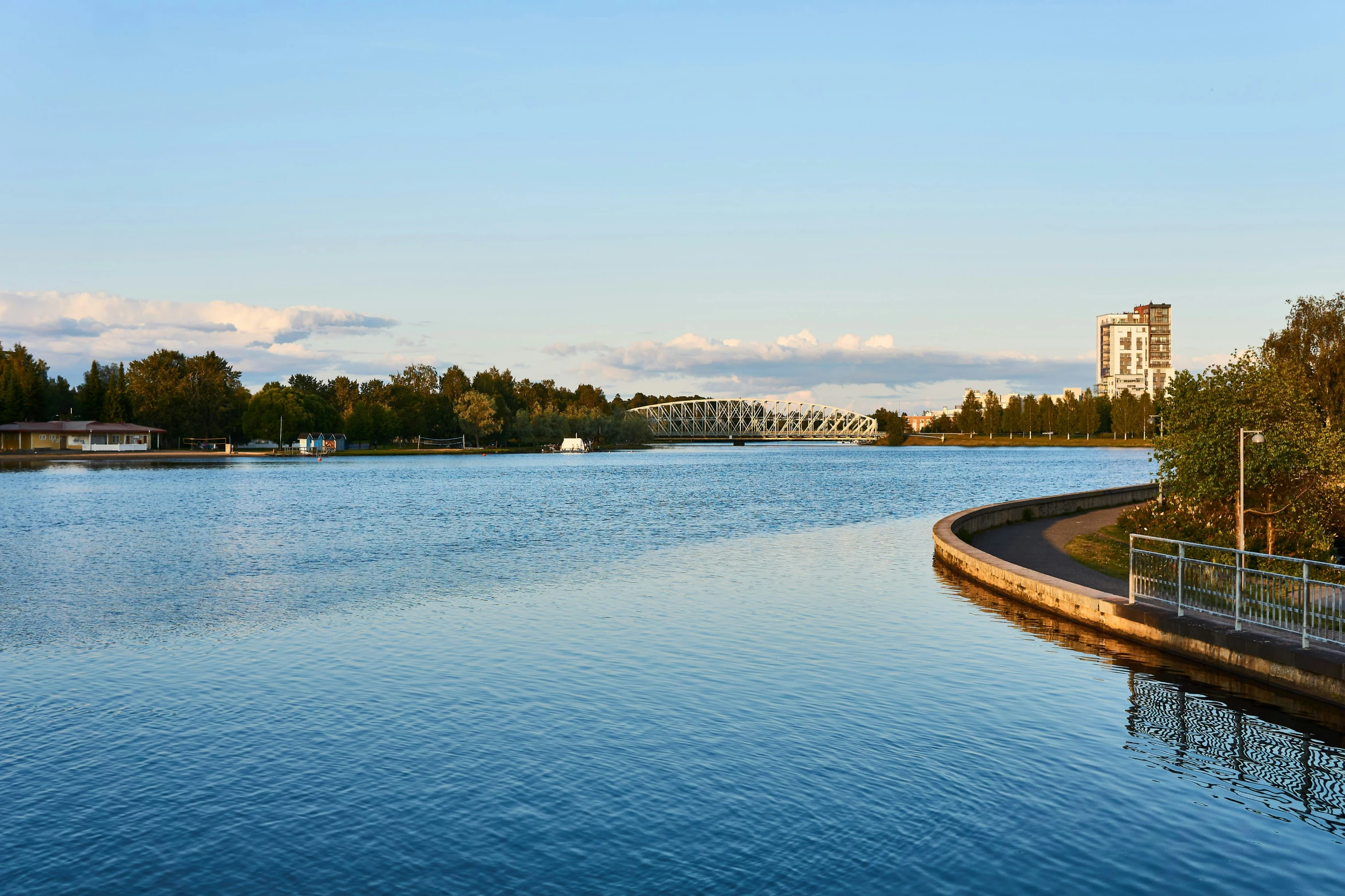 a body of water with trees on the side