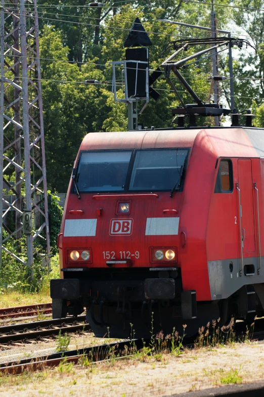 a red train that is traveling down the tracks