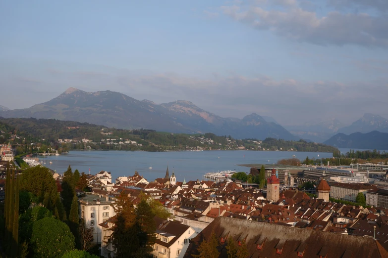 a scenic po of city surrounded by mountains