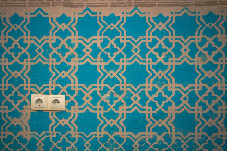 the blue wall has an intricate design on it