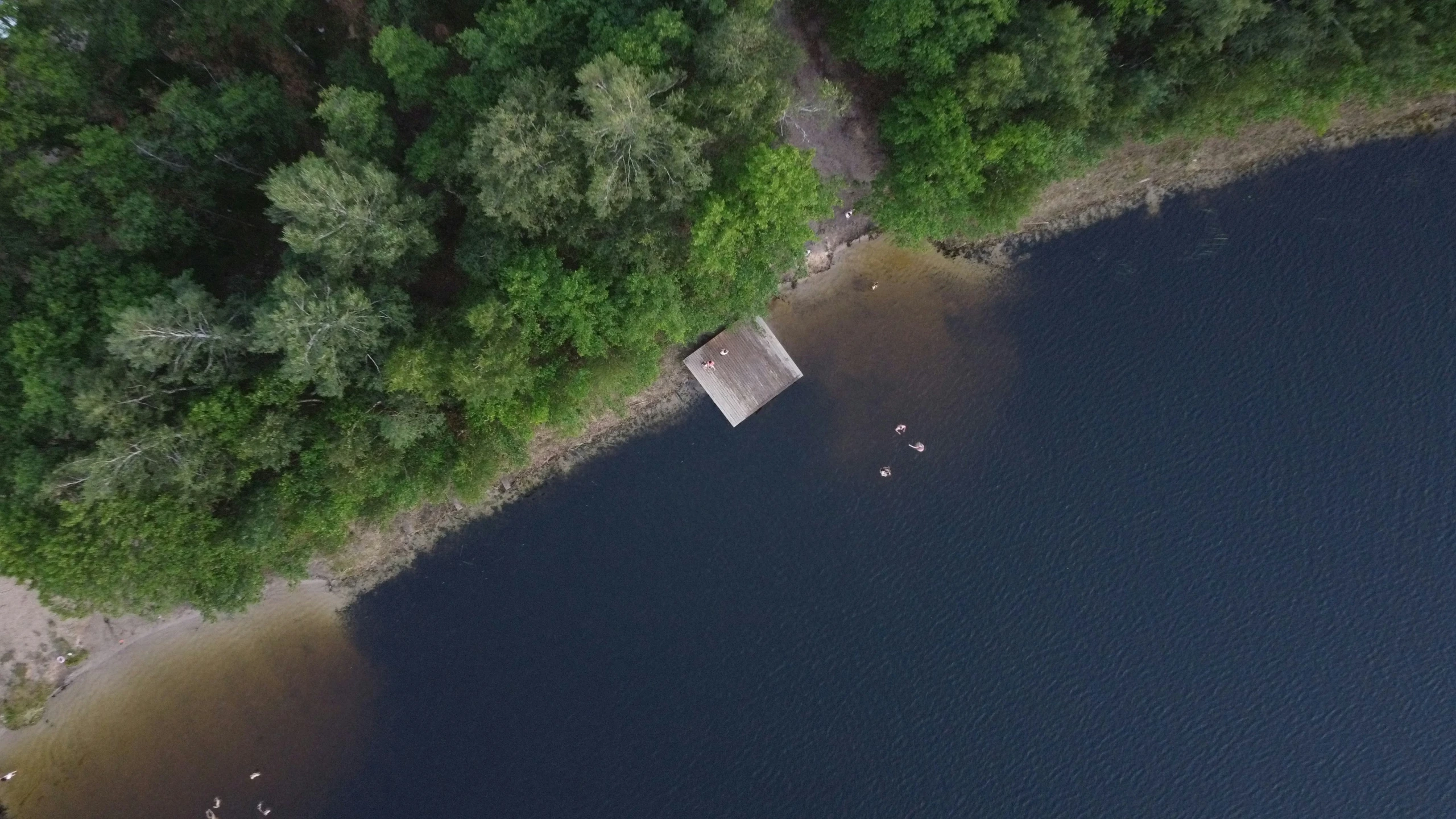 aerial view of small wooden boat tied to a dock