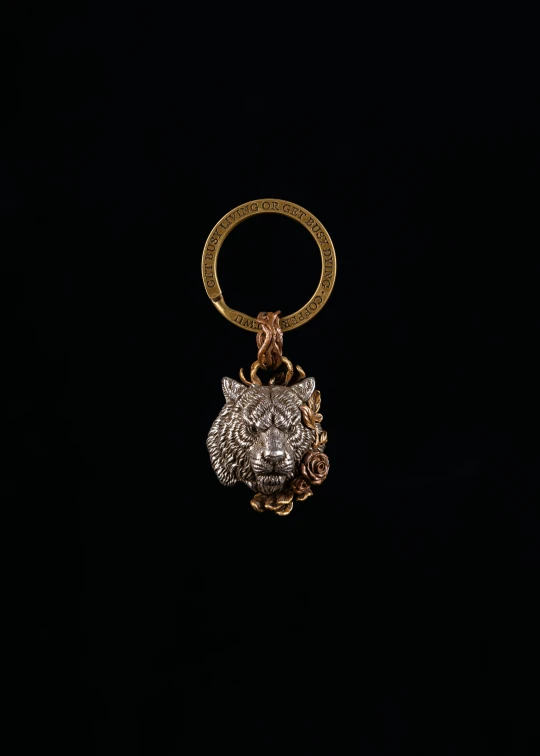 a gold ring with an animal charm