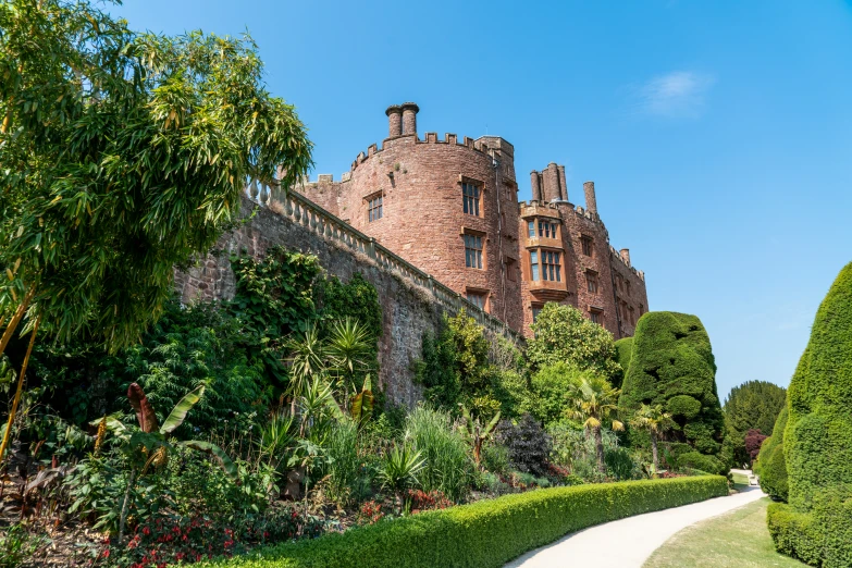 a building with a stone facade and ivy lined garden