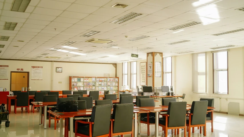 a room with tables and chairs is filled with computer equipment