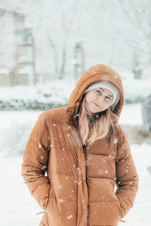 a woman in brown standing on the snow