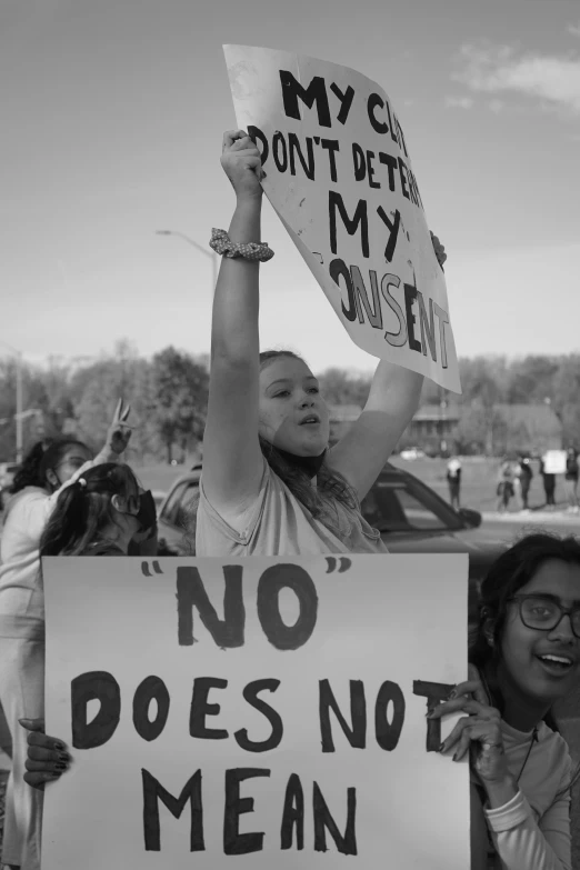 a young person holding a sign with words on it