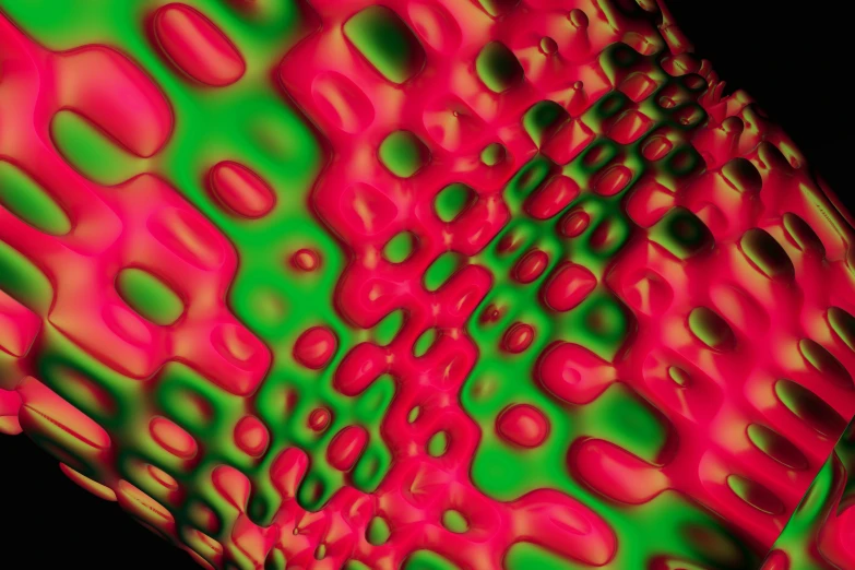 a red and green substance on a black background