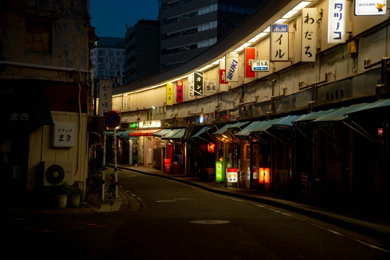 a city street with chinese signs above shops