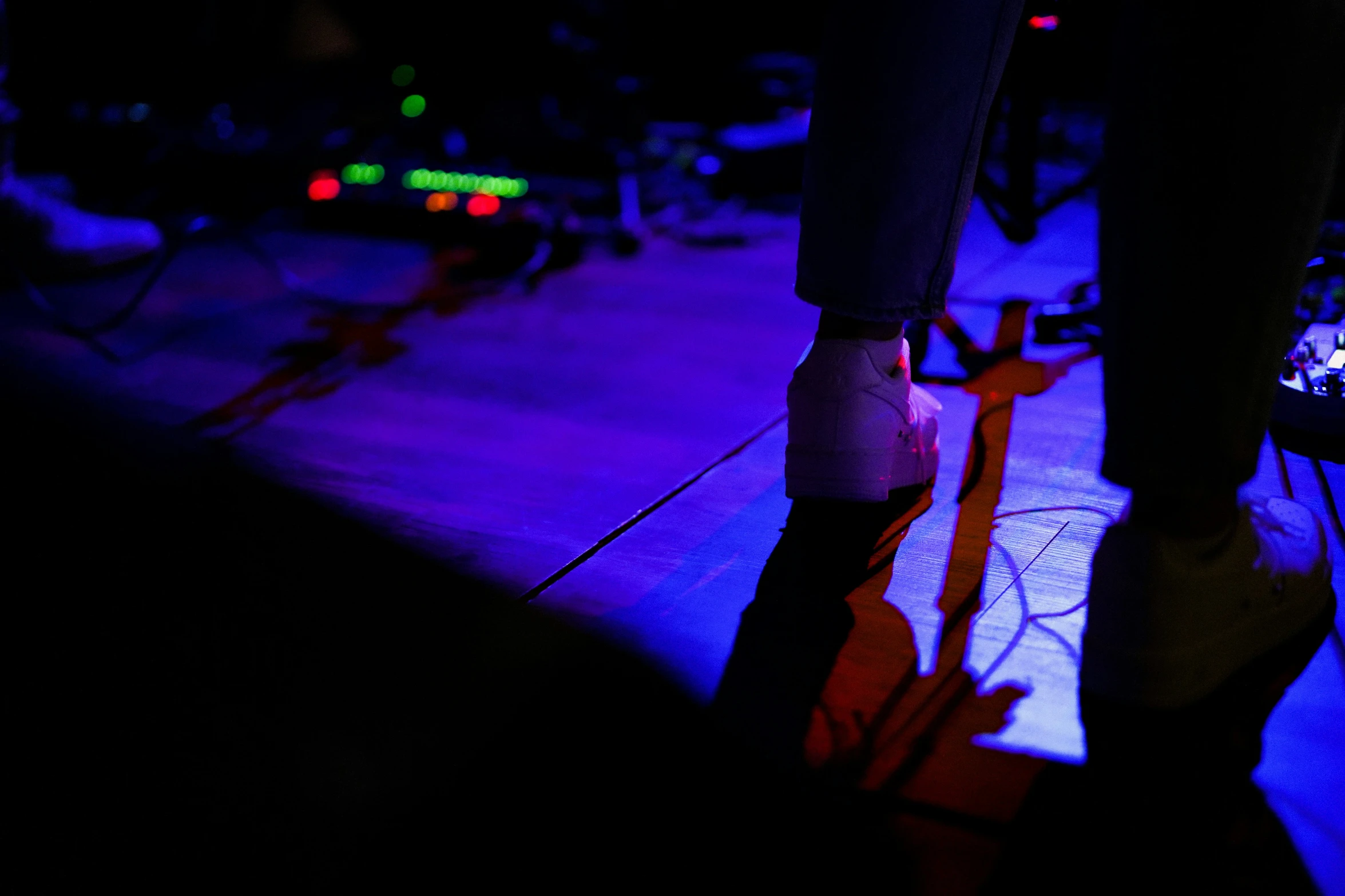 a lit up floor with several people playing instruments