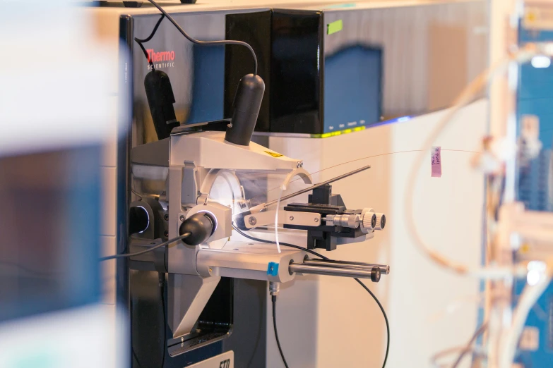 a machine working on soing in front of a wall