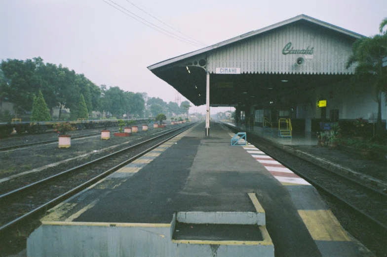 a train station with a few cars near the platform