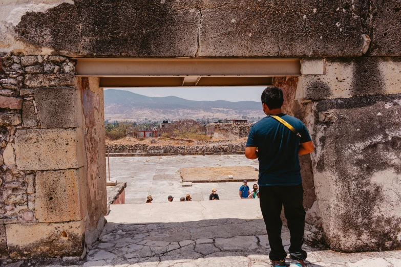 a man standing in an entrance way to the city