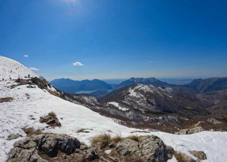 a group of skiers and some snow covered mountains