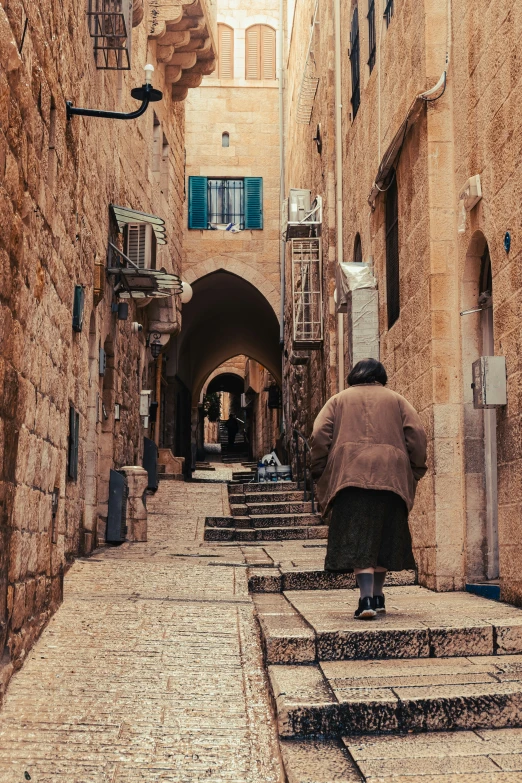 this man is going up some steps to an underground alley way