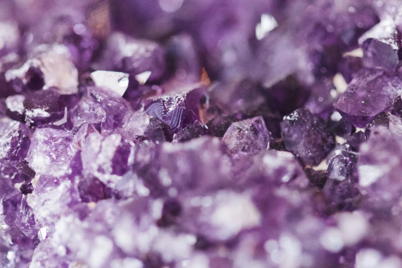 purple crystals are in close up with a blurry background