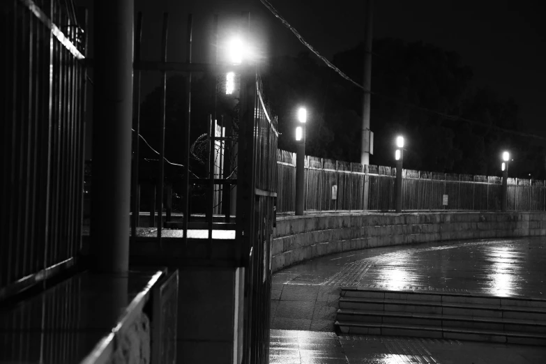 black and white pograph of the light of a street in rain