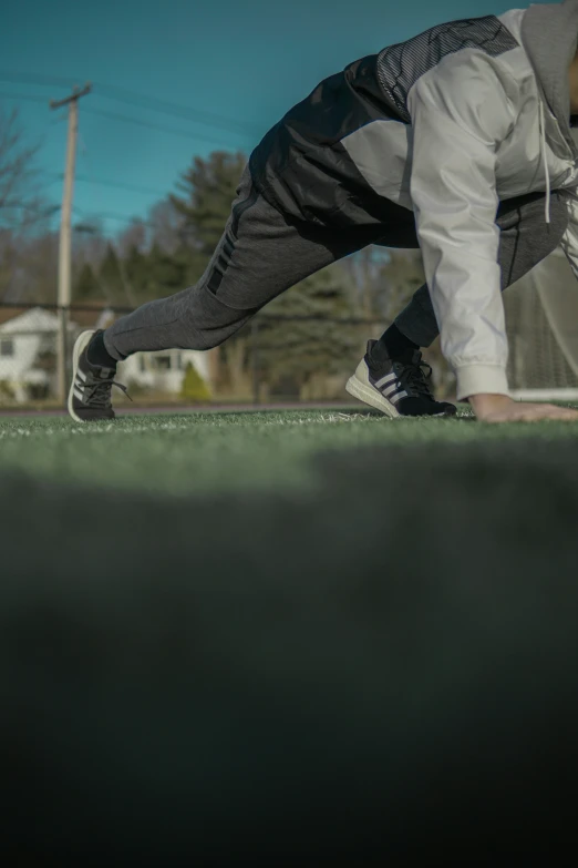 a man playing catch in the park with his sneakers