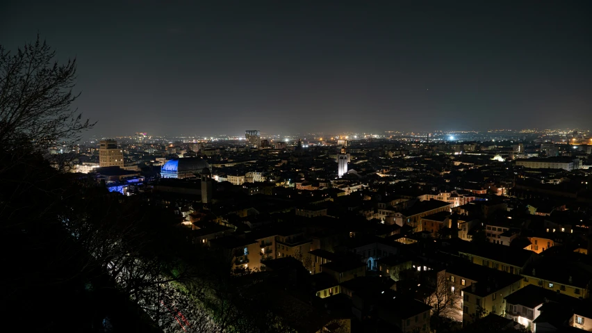 view over city at night from hill above it