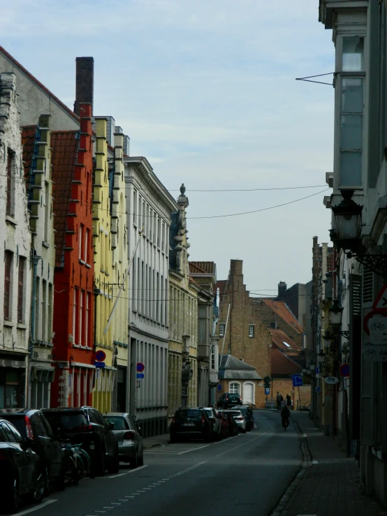 street view of an empty street and many parked cars