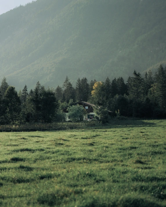 a farm and barn in the middle of an open field