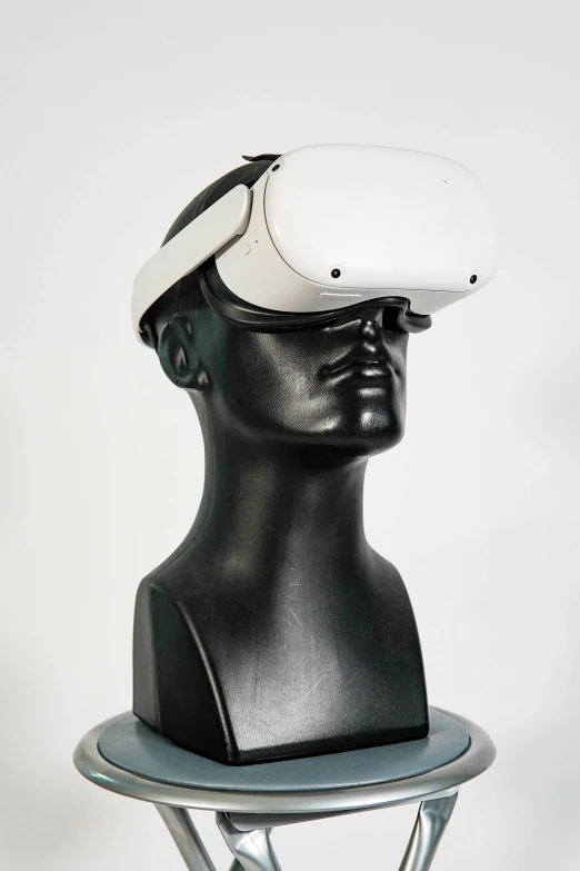 a head mounted on top of a black plastic stand