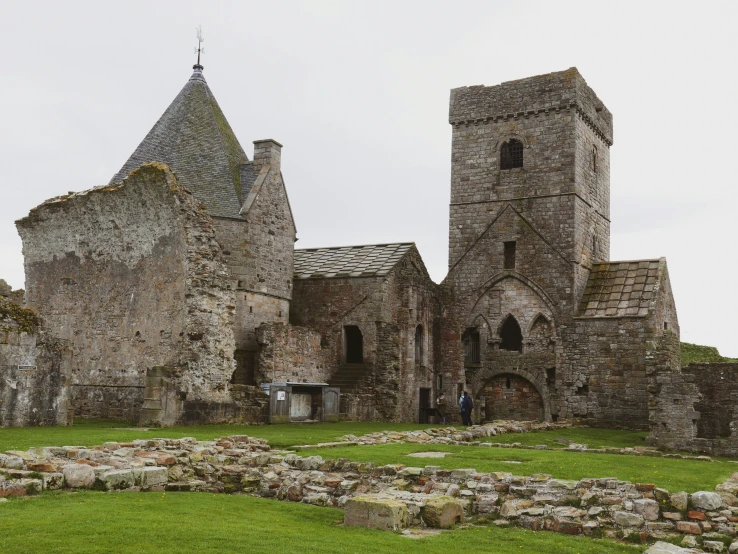 a view of a stone building with many walls and towers