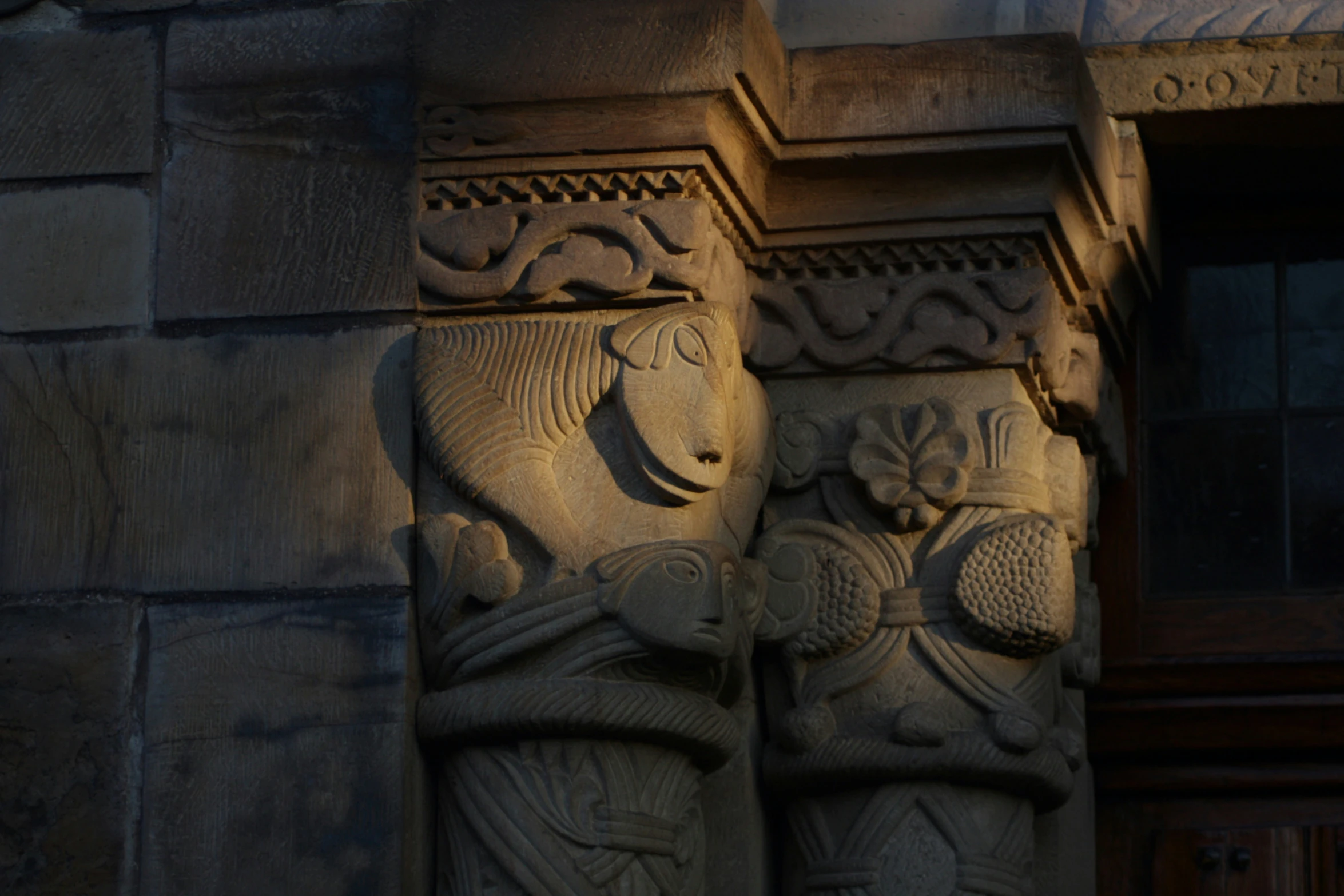 a close up of two carvings on the outside wall