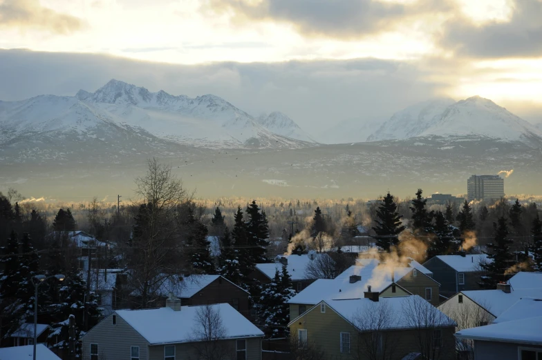 the skyline shows the snow covered mountains and houses