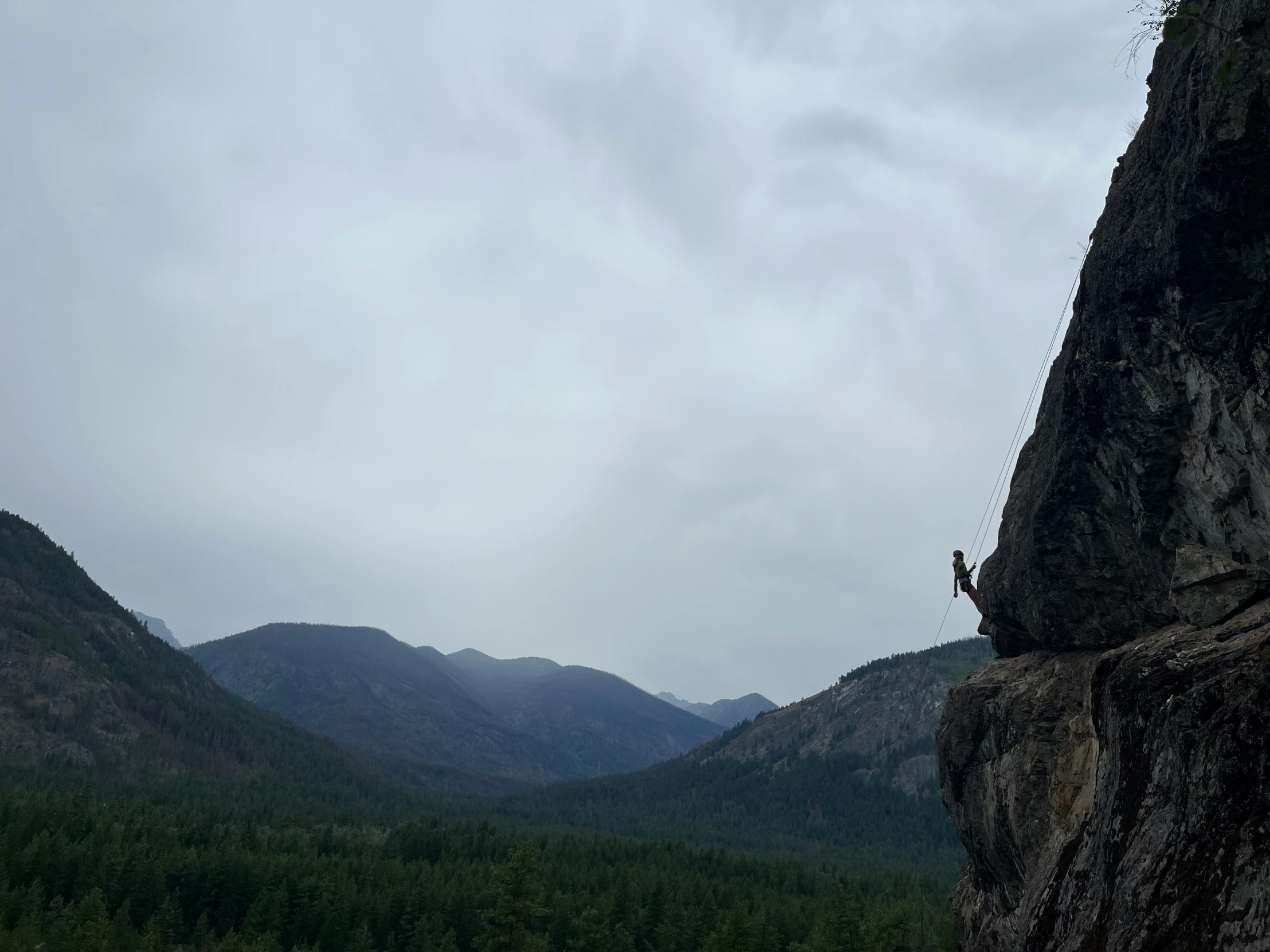 a person standing on the edge of a cliff,