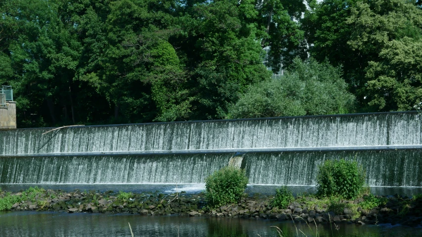 a man walks next to the water wall