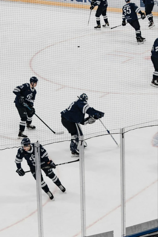 hockey players are playing on an ice rink