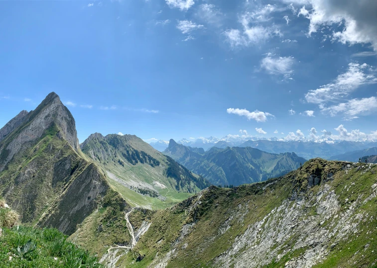 there is a very tall peak that is above green hills