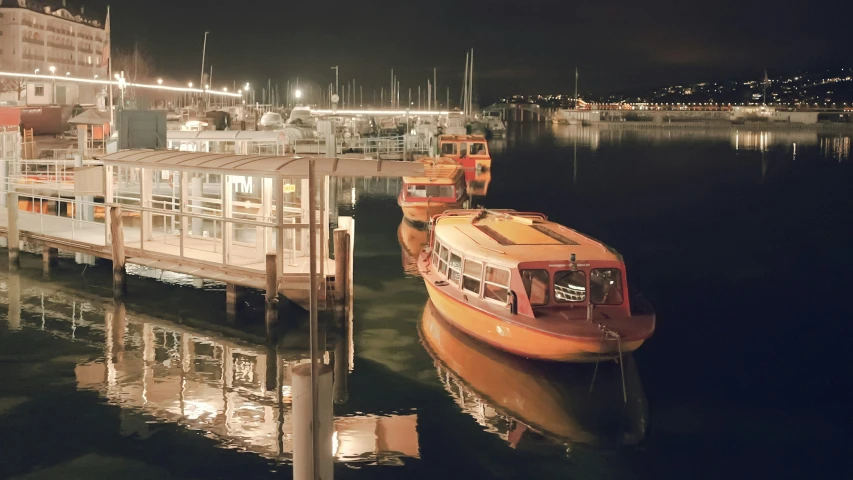 a boat docked in a marina at night