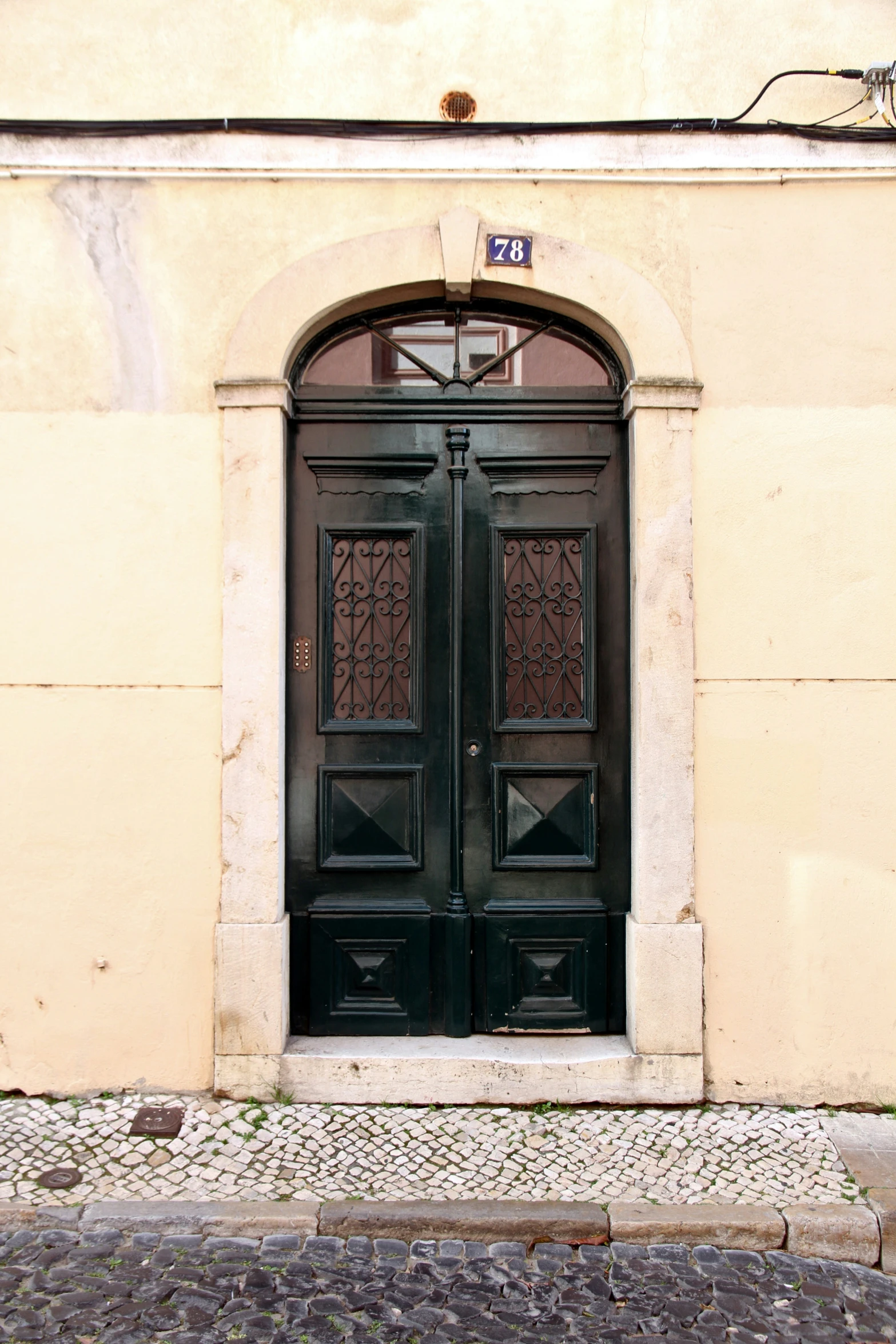 there is an old door in front of a building