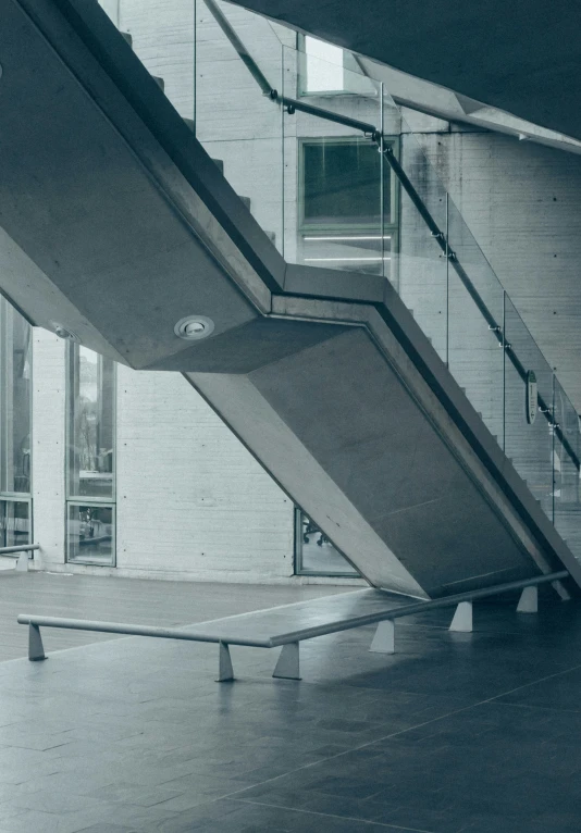 a bench sits near some steps in an empty space