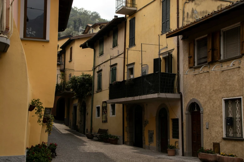 an alley in a city with a row of buildings