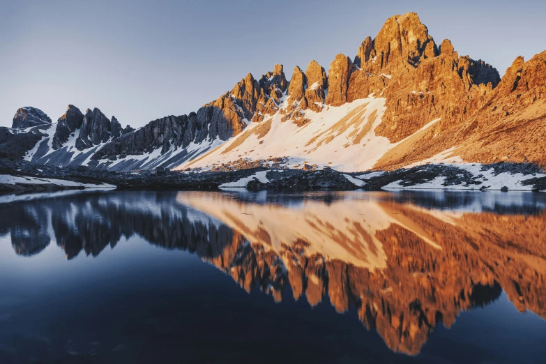 snow - capped mountains with a reflection in the water