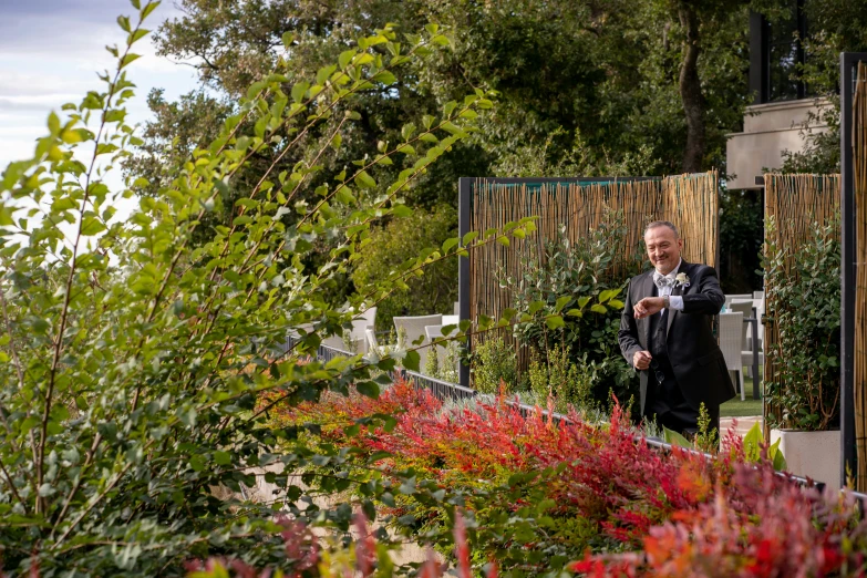 man standing in a garden taking a selfie