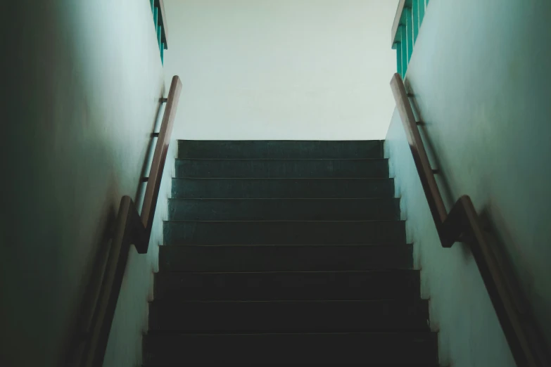 a staircase is going down the light blue walls