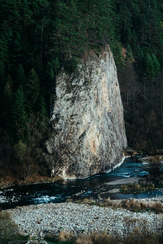 a large rock that is surrounded by a mountain