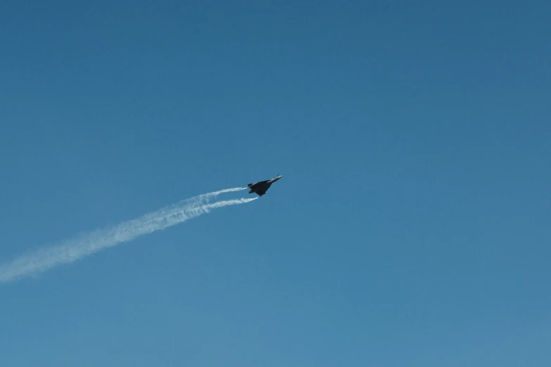 a plane is flying upside down on a clear day