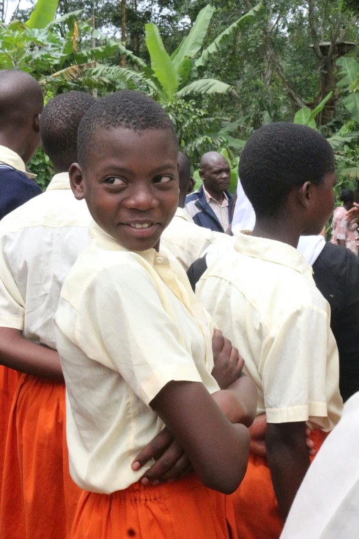 two boys are standing together, with arms wrapped around each other