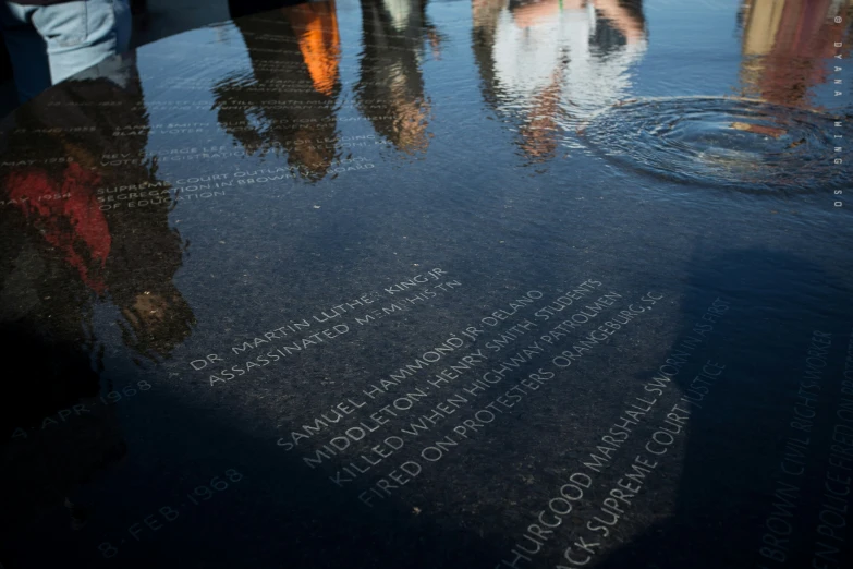 there are people standing on the memorial