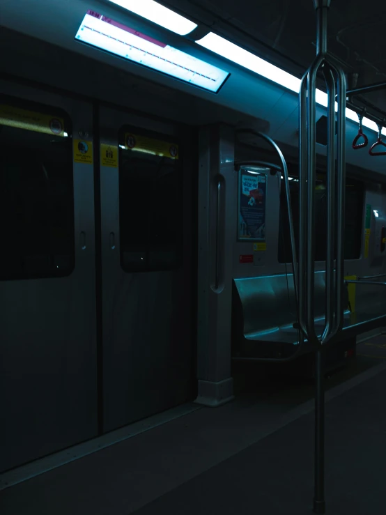 a long empty train next to a terminal