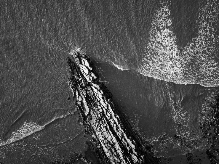 a lone boat floats on the water near the shore