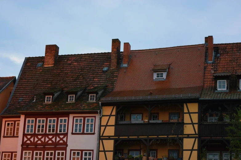 row of multicolored houses with a brown roof